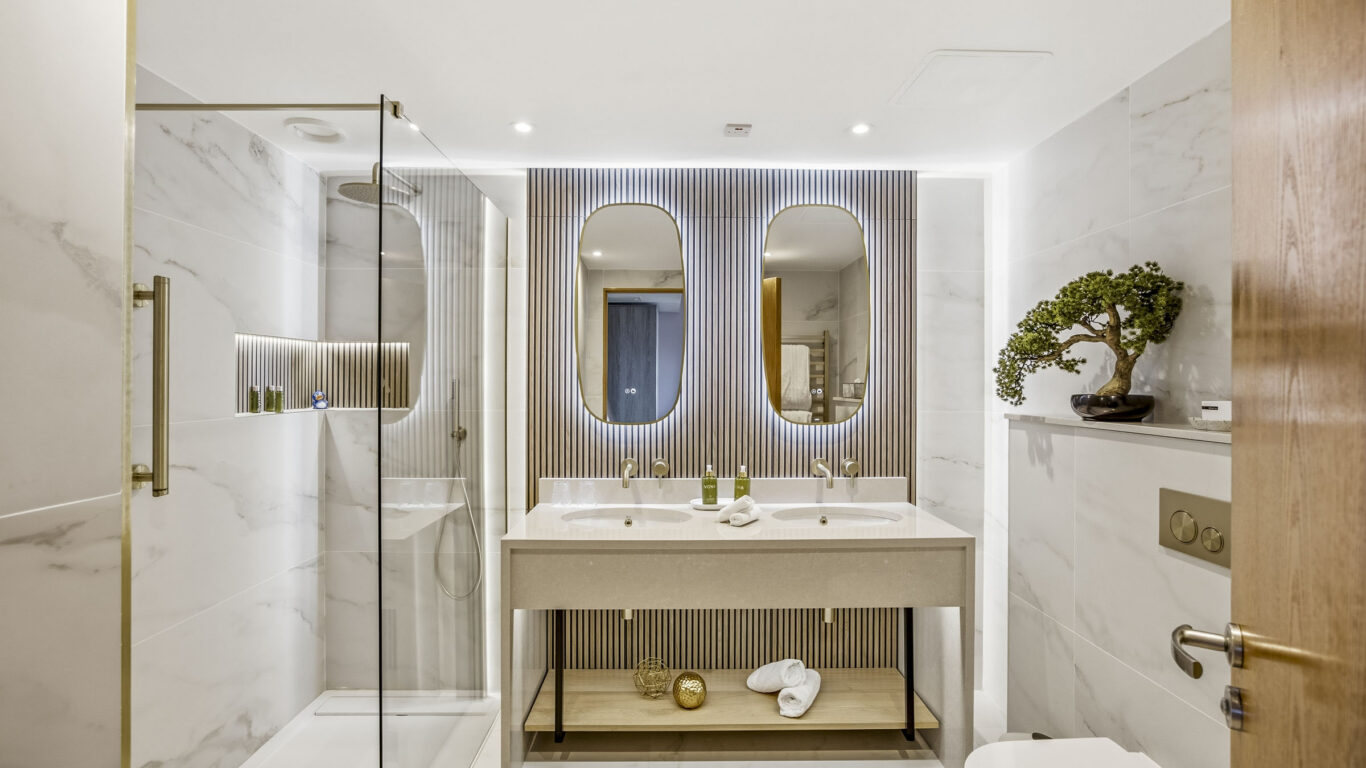 Elegant hotel bathroom with rainfall shower, modern double sinks, and ambient lighting, perfect for a luxurious stay.